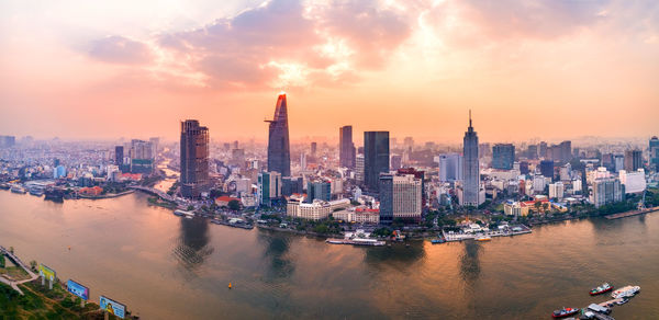 Aerial view of city lit up at sunset