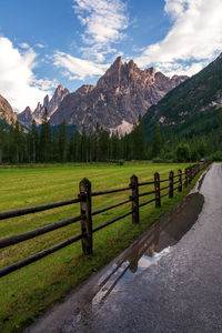 Scenic view of field and mountains against sky