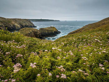 Scenic view of sea against sky in brittany, with the point du raz in the background