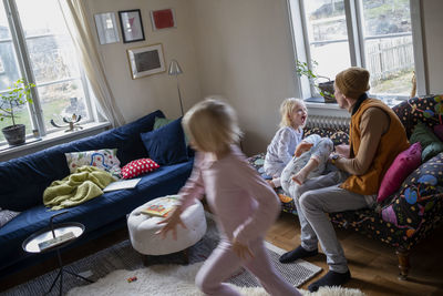 Sisters sitting on sofa barefoot