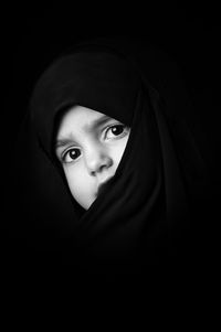 Portrait of girl against black background