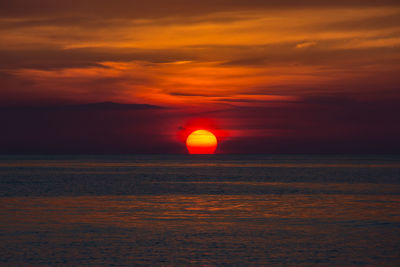 Scenic view of sea against romantic sky at sunset