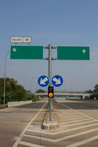 Road sign against blue sky