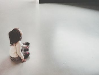 Rear view of girl standing on floor