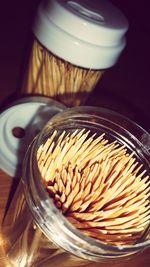 Close-up of toothpicks in container on table