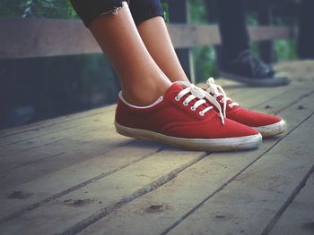 Low section of woman legs on footpath