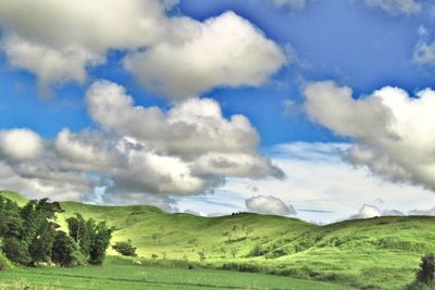 Scenic view of landscape against cloudy sky