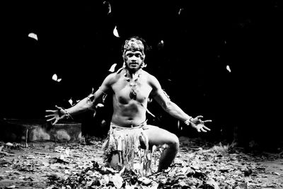 Portrait of young man sitting on land