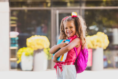 Portrait of smiling girl standing outdoors