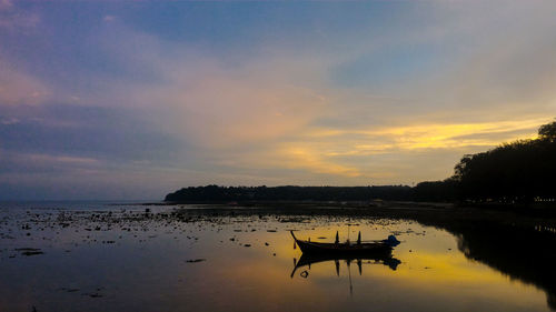 Scenic view of lake against sky during sunset
