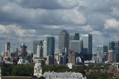 View of cityscape against cloudy sky