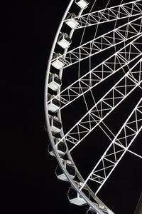 Low angle view of ferris wheel against sky at night