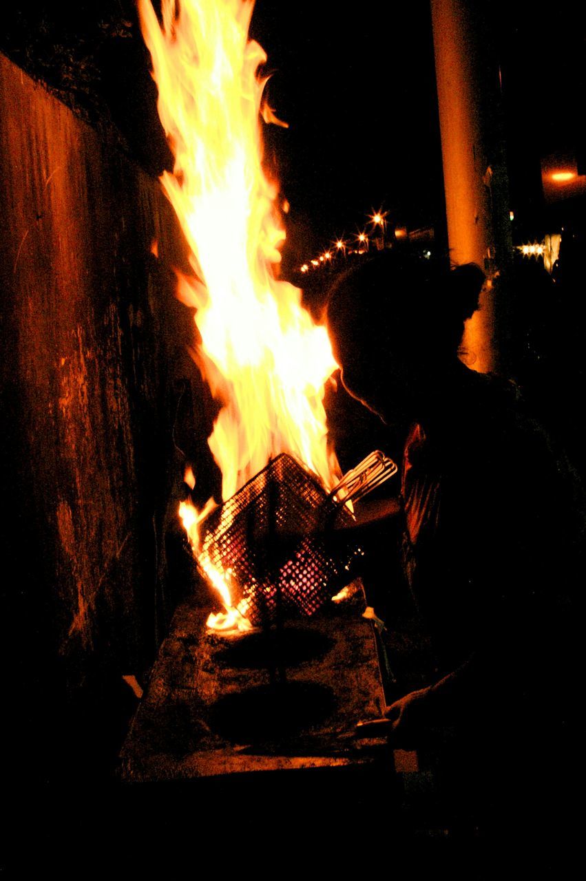 night, illuminated, fire - natural phenomenon, burning, flame, glowing, long exposure, heat - temperature, motion, fire, dark, sparks, bonfire, light - natural phenomenon, outdoors, firewood, building exterior, light trail, built structure, no people