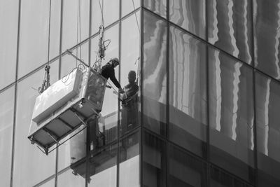 Low angle view of men working on building