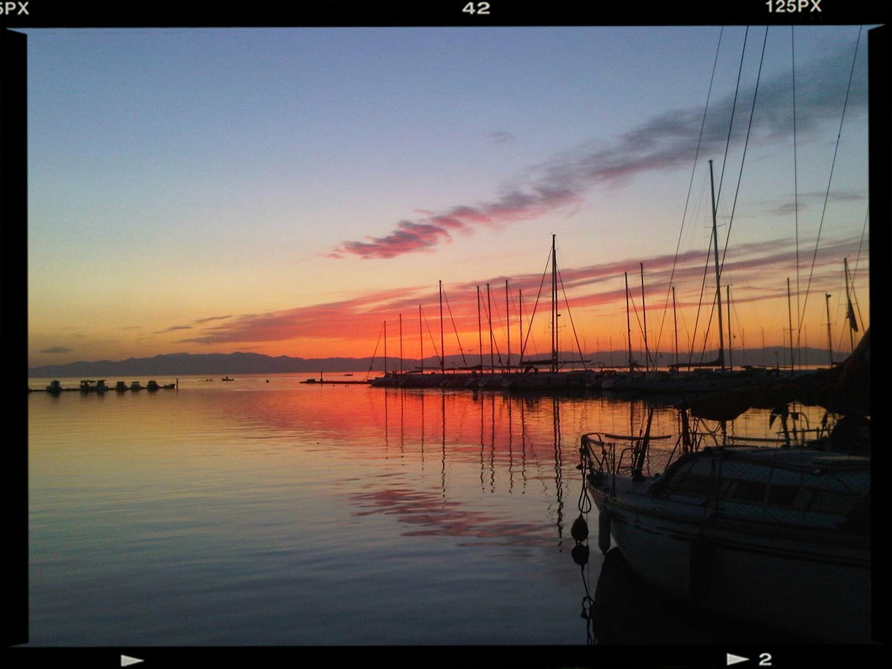 sunset, water, transfer print, sea, nautical vessel, sky, transportation, boat, auto post production filter, scenics, moored, mode of transport, tranquil scene, beauty in nature, tranquility, orange color, nature, cloud - sky, reflection, silhouette