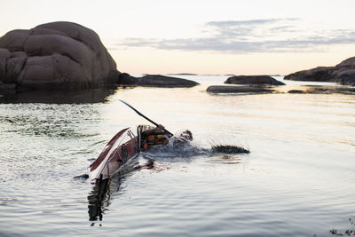 Man falling into water while kayaking