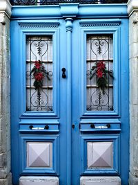 Christmas decoration on sky blue doors. 