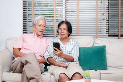 Friends sitting on sofa