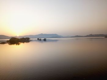 Scenic view of lake against sky during sunset