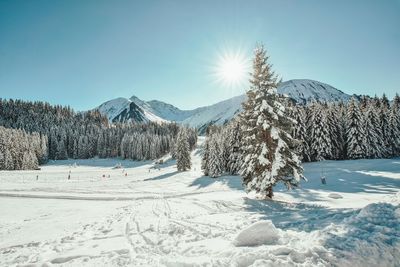 Scenic view of snow covered mountains against sky