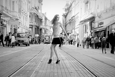 Fashionable young  woman crossing the street