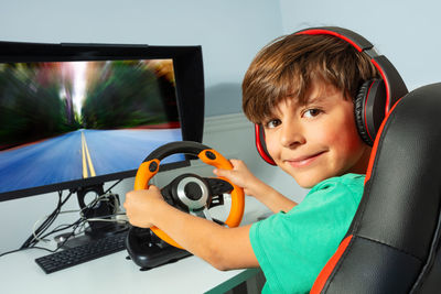 Side view of boy looking away while sitting in car