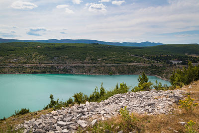 Scenic view of lake and mountains against sky