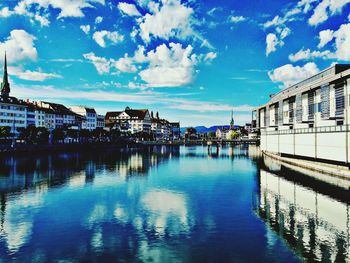 Buildings in city against cloudy sky