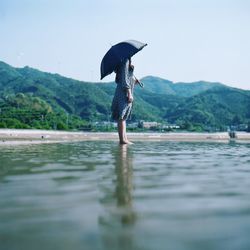 Full length of man on beach against clear sky