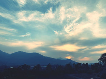 Scenic view of silhouette mountains against sky at sunset