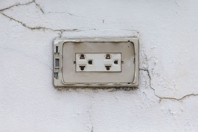 Close-up of telephone booth on wall