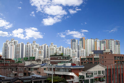 Buildings in city against sky