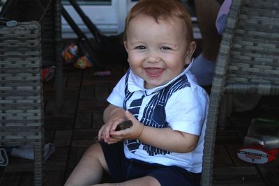 Portrait of smiling boy sitting outdoors