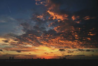 Scenic view of silhouette trees against sky at sunset