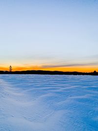 Scenic view of frozen sea against sky during sunset