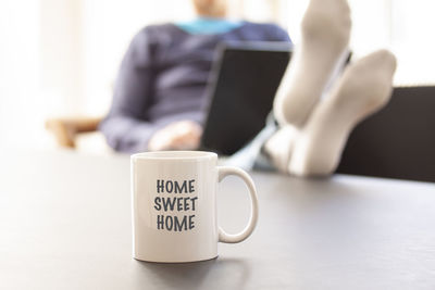 Close-up of coffee cup on table at home