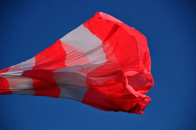 Low angle view of flag against blue sky