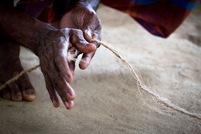 Hands weaving coconut rope