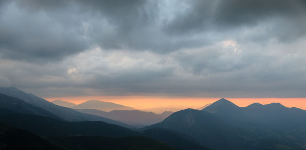 Scenic view of mountains against dramatic sky