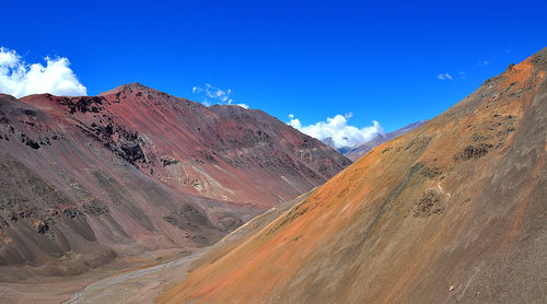 Scenic view of mountains against blue sky