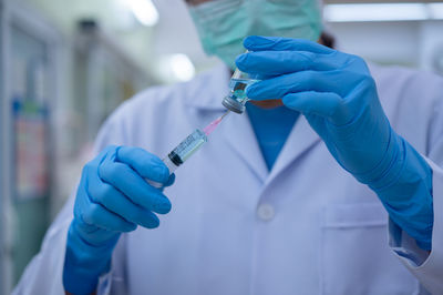 Midsection of person holding umbrella