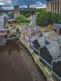 High angle view of buildings by canal in city
