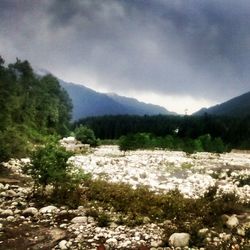 Scenic view of mountains against cloudy sky