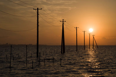 Evening view of the sea painting and the utility poles that continue