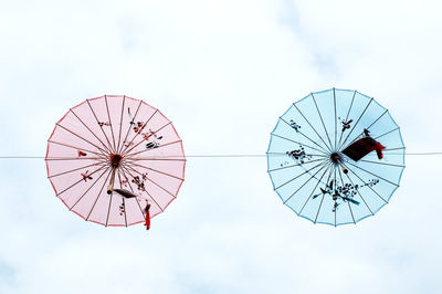 Low angle view of ferris wheel against sky