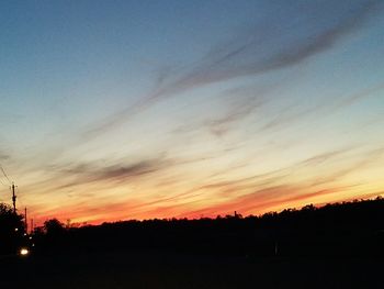 Scenic view of silhouette landscape against sky at sunset