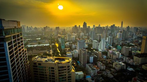 High angle view of buildings in city against sky during sunset