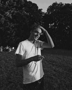 Man wearing sunglasses standing on field