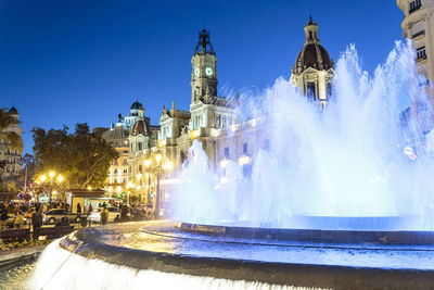 Panoramic view of illuminated buildings in city against sky at night