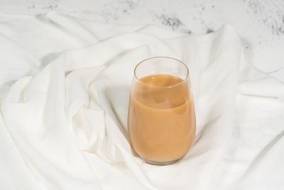 High angle view of beer glass on bed